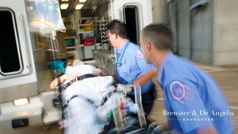 EMT workers putting an injured person in ambulance.