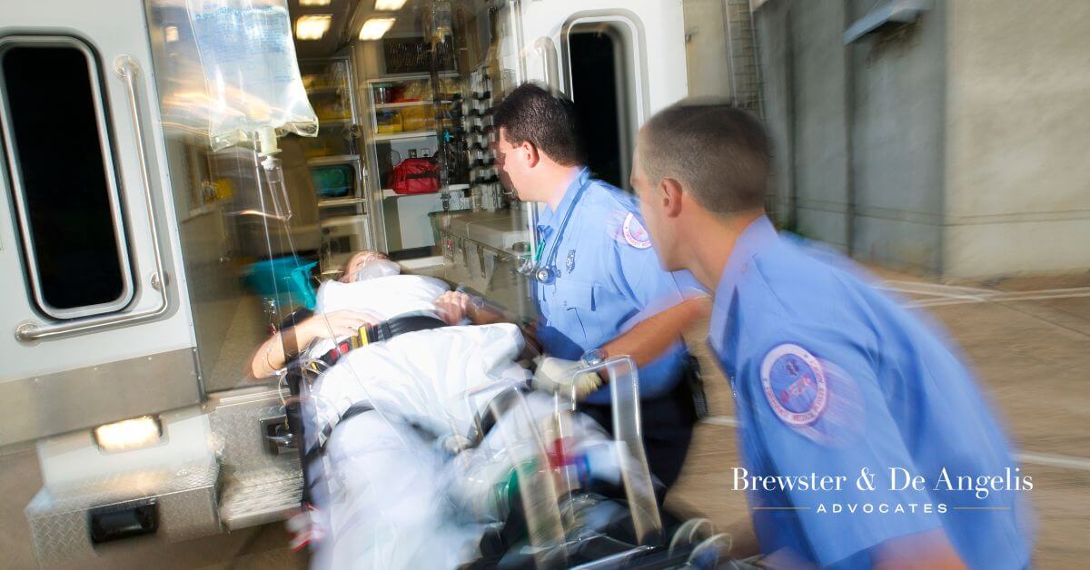 EMT workers putting an injured person in ambulance.