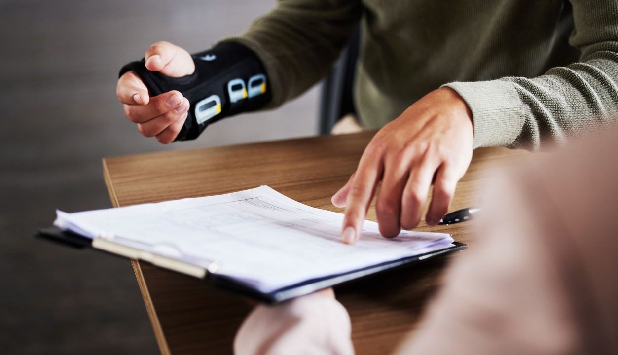 injured worker pointing at paperwork