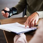 injured worker pointing at paperwork