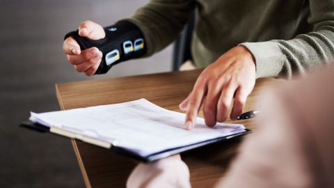injured worker pointing at paperwork